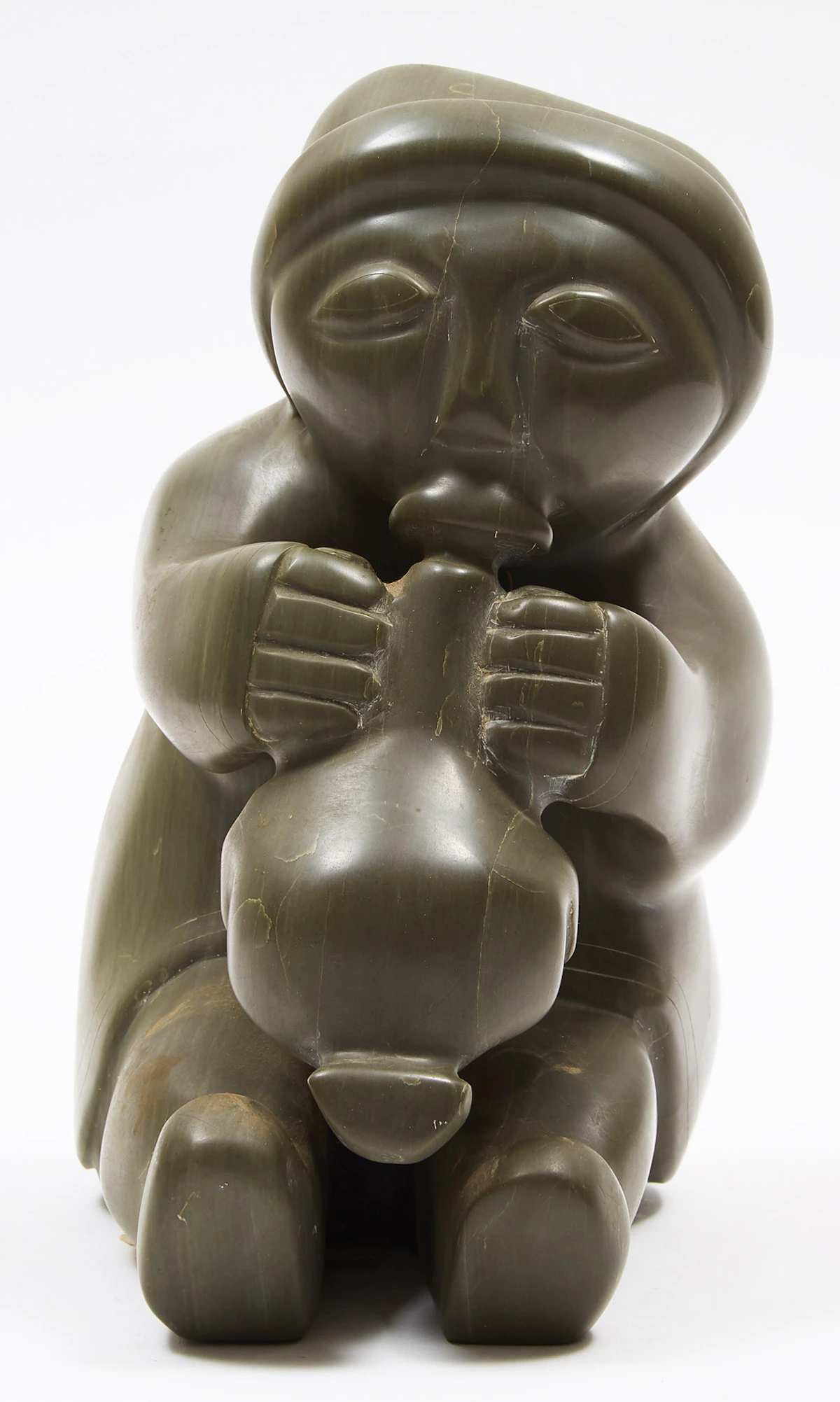 Unidentified Inuit Artist (Sanikiluaq), Woman Blowing up a Sealskin Float, stone