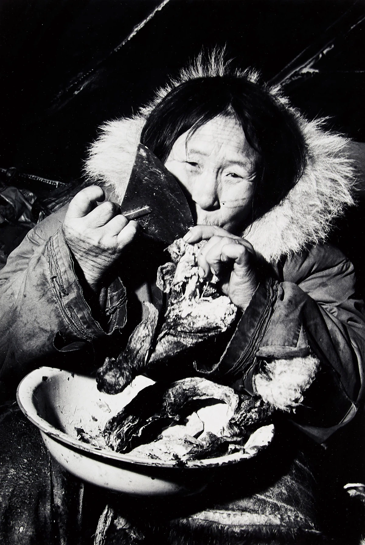 Richard  Harrington, Eskimo Woman Eating Caribou Meat , gelatin silver print, 1949