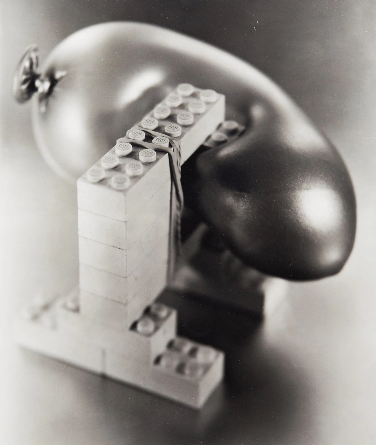 Damian Moppett, Untitled (B&W Lego Pcs-Rubber Band), black and white photograph mounted on board
